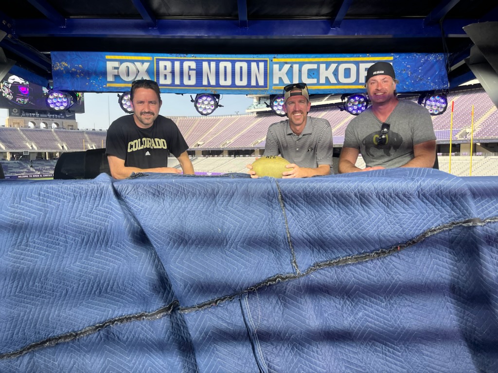 One Buff Solutions team seated at the FOX Big Noon Kickoff desk